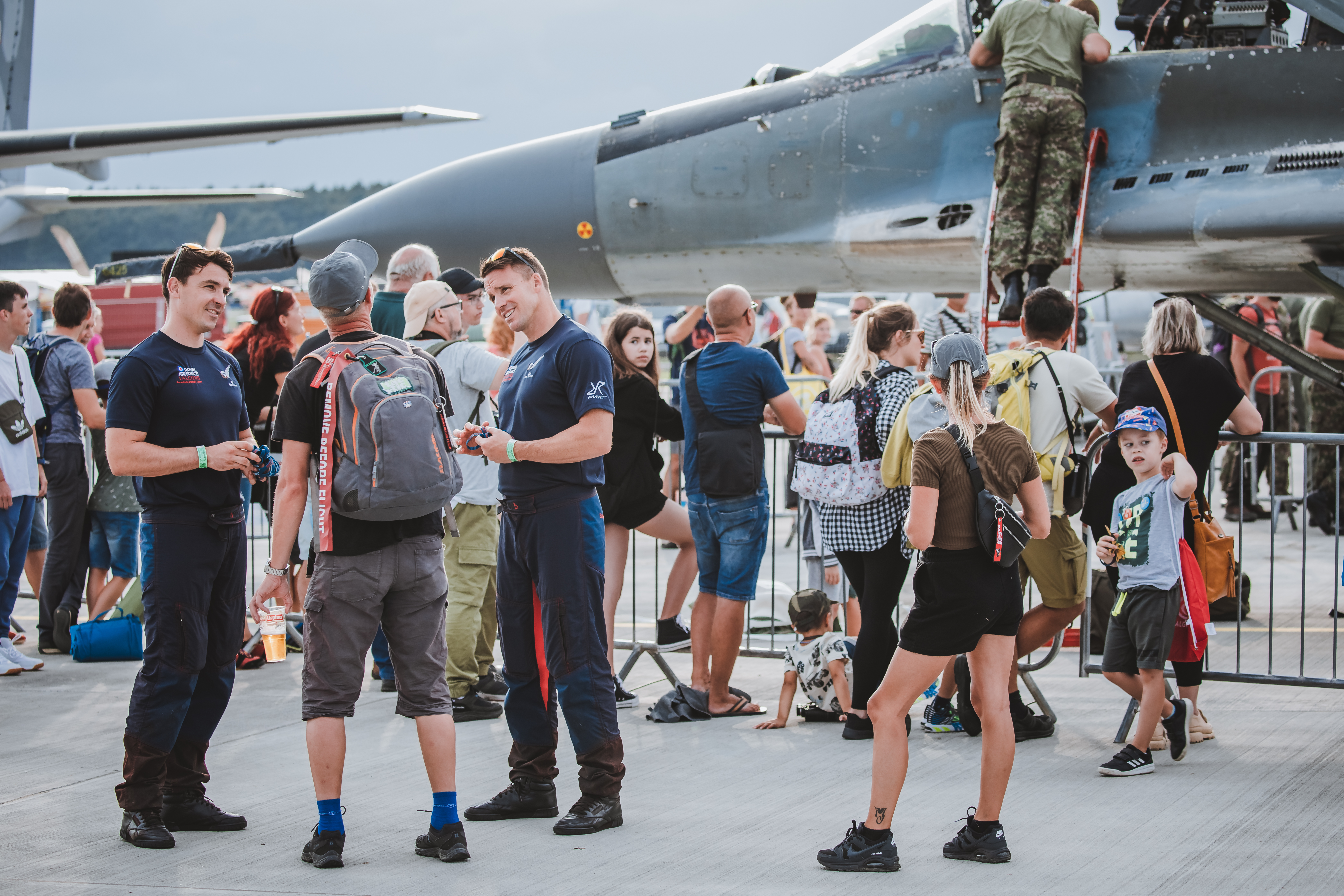 Image shows RAF aviators interacting with public on airfield.